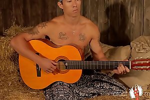 Gay asian muscle guitarist plays with